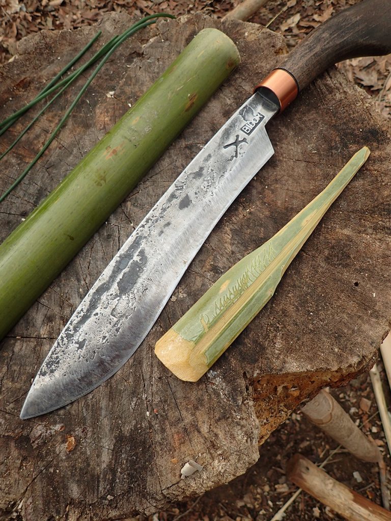 The Golok 125 next to a freshly carved bamboo spoon